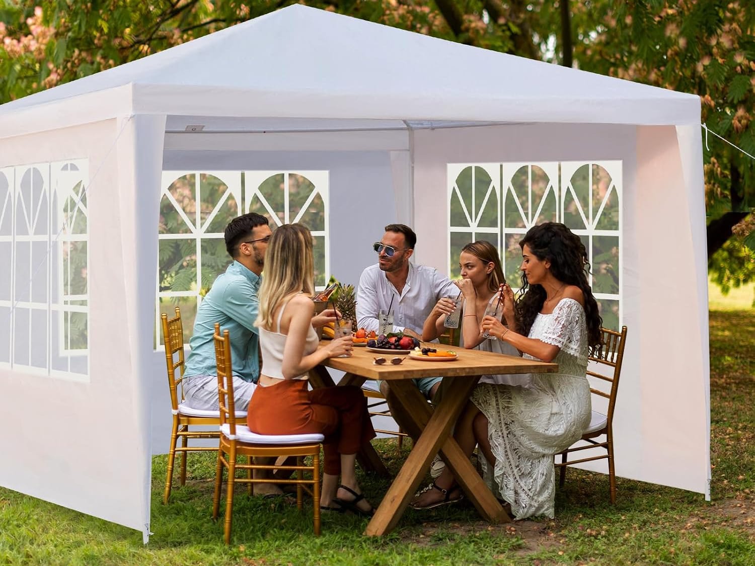 Neighbours gathered under a canopy, sharing food and conversation.